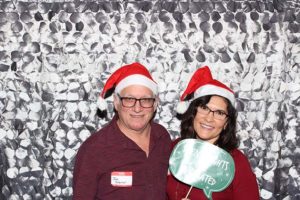 Two people in Santa hats at holiday photo