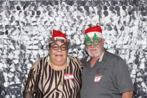 Couple in Santa hats and festive glasses