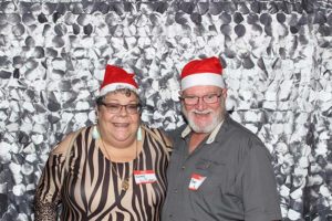 Smiling older couple wearing Santa hats
