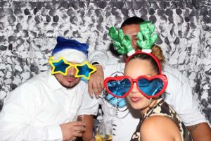 Three people wearing novelty glasses and headbands