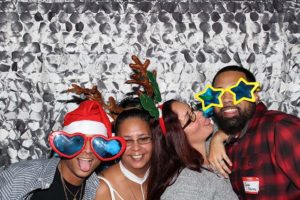 Group of friends wearing holiday novelty glasses