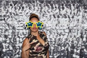 Woman in star sunglasses posing with peace sign