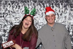 Smiling couple in Santa hat and antlers