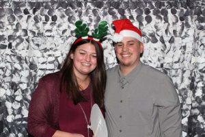 Smiling couple with Santa hat and antlers