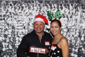 Smiling couple in Santa hat and reindeer antlers