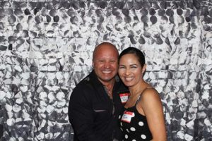 Smiling couple in photo booth with sequins