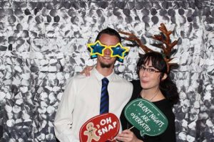 Couple wearing holiday photo booth props