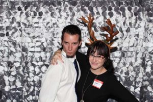 Couple posing, woman wearing reindeer antlers