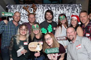 Group of friends wearing Christmas accessories at party