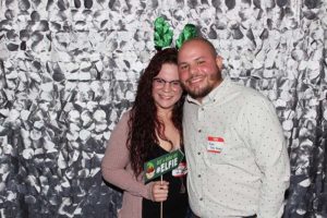 Smiling couple in photo booth with antlers