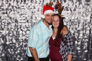 Couple wearing Santa hat and reindeer antlers