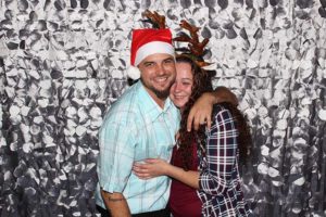 Couple hugging with Santa hat and antlers