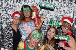 Women in Christmas photo booth with props