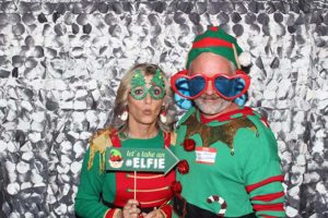 Adults in elf costumes with novelty glasses