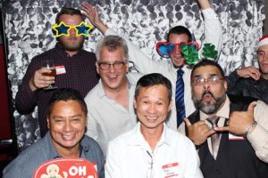 Group of men wearing novelty glasses at party