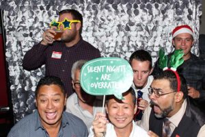 Men in festive holiday party photo booth