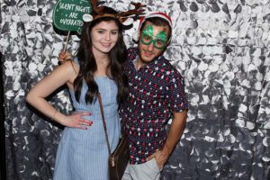 Couple in festive costumes posing at photo booth