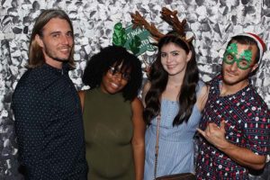 Group of four friends wearing festive accessories