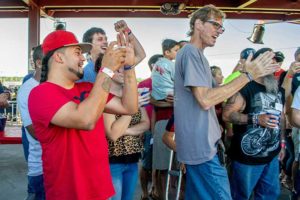 Crowd cheering and applauding at outdoor event