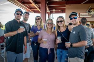 Group of people holding drinks at outdoor patio