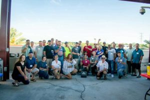 Large group posing for a photo under pavilion