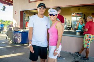 Two people smiling at outdoor concession stand