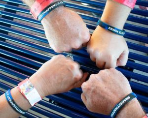 Four fists with matching wristbands