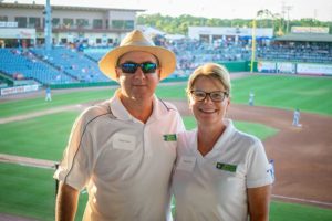 Two adults smiling in baseball stadium