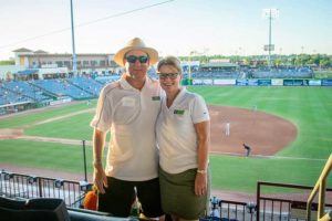 Couple smiling at baseball stadium