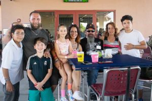 Group of people smiling around outdoor table
