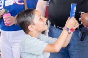 Smiling child taking a selfie with phone