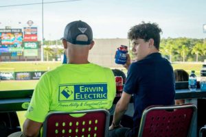 Man in Erwin Electric shirt at stadium