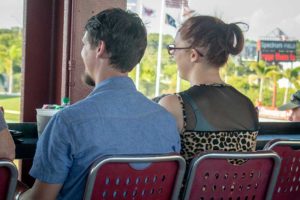 Couple seated on red stadium seats outdoors