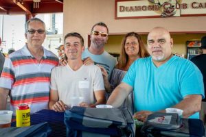 Five adults smiling at outdoor bar