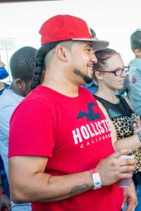 Man in red Hollister shirt smiling at event
