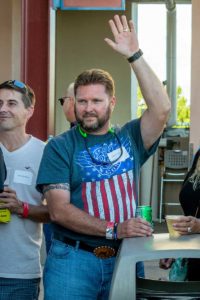 Man raising hand wearing American flag t-shirt